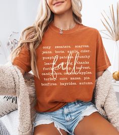 Embrace cozy season with this fall season crewneck shirt that showcases a charming fall aesthetic of autumn activities! Perfect for fall lovers, this Comfort Colors fall shirt is great for a day at the pumpkin patch or celebrating Thanksgiving. Designed for those who love the warmth of the season, this cozy season shirt is a must-have for your wardrobe. Whether you're looking for a pumpkin patch shirt or a Thanksgiving shirt women will love, this aesthetic fall tee captures the "tis the season" Casual Brown T-shirt For Fall, Cozy Orange Crew Neck Top, Cozy Graphic Print Tops For Fall, Everyday Cotton T-shirt For Fall, Everyday Fall T-shirt With Graphic Print, Fall Graphic Print T-shirt For Everyday, Everyday Fall T-shirt With Letter Print, Trendy Fall Letter Print T-shirt, Brown Graphic Print T-shirt For Fall