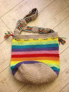 a multicolored crocheted bag on the floor