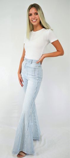 Feel-good retro stripes. An updated throwback, these jeans are cool! The high waist denim jeans fit snugly to the knee then flare to a bell bottom. The denim has light wash stripes with front and back square pockets to give that retro feel. A great pair of lightweight jeans to wear all year long. Color- Light Blue and White 65% Cotton 33% Polyester 2% Spandex Trendy Cotton Jeans With Vertical Stripes, Striped Straight Leg Denim Jeans, Striped Straight Leg Cotton Jeans, Trendy White Spring Flares, Casual Striped Flare Bottoms, Casual Flared Striped Bottoms, Trendy Bottoms With Striped Hem For Spring, Spring Striped Flare Bottoms, Trendy Blue Bottoms With Vertical Stripes