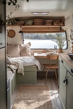 the interior of a camper with a bed and desk