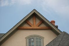 the top of a house with a window and roof