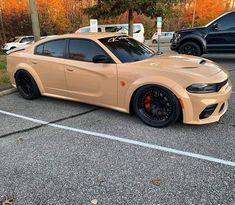 a tan sports car parked in a parking lot