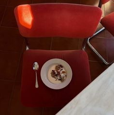 a bowl of food is sitting on a red chair