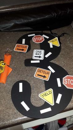 the road is made out of cardboard and has stickers on it that say stop