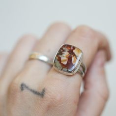 This Unisex Red Creek Jasper Ring is all about the stone. Minimal embellishments except for exceptional silversmithing on these big, cushion cut rectangles. While they last! Red creek jasper with .925 Sterling Silver Double half-round split shank. You choose your size and your one-of-a-kind stone from the drop-downs. Good luck - all the stones are beautiful! The original ring will be listed separately as a ready-to-ship. Red Creek Jasper Cushion Rectangle - 16x20mm .925 Sterling Silver 5/8x3/4 inch All traditional silver work is done in my Baltimore, MD studio. Red Creek Jasper are excellent healing stones that encourage a feeling of joy and elevated spirits! As they help you to release negative feelings, you feel more optimistic. At Linda Blackbourn Jewelry I've tried my best to describe Rings With Big Stones, Jasper Gemstone Rings As A Gift, Jasper Gemstone Rings For Gifts, Jasper Gemstone Rings Gift, Gift Jasper Gemstone Rings, Red Jasper Jewelry, Red Creek Jasper, Silversmithing Jewelry, Jasper Ring