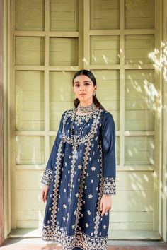 Pakistani Blue Dress in Frock Trouser Style for Eid is a traditional masterpiece to have a charismatic appearance on the festive occasion. This stunning Frock and Churidar is adorned with lavish designs and embroidery, making this attire your foremost priority to have a head-turning appearance. Frock: The beautiful Pakistani Frock in an alluring blue shade comes in premium cotton fabric. The beautifully stitched Pakistani Blue Dress is adorned with graceful embroidery work and threads. Floral de Traditional Raw Silk Dress For Reception, Traditional Dresses With Zari Work For Reception, Traditional Zari Work Dresses For Reception, Raw Silk Reception Dress With Zari Work, Designer Embroidered Dress For Eid, Designer Mirror Work Dresses For Eid, Eid Dress With Intricate Embroidery In Raw Silk, Eid Raw Silk Dress With Intricate Embroidery, Festive Raw Silk Dress For Eid