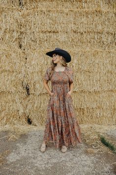 Unleash your inner free spirit with the Indigo Dress! With a flattering square neckline, smocked bodice, and puff sleeves, this midi dress exudes bohemian vibes. The tiered skirt and vibrant floral print add a touch of Western flair. Perfect for making a statement at any event! Courtney is wearing size small paired with the Felt Cowboy ProHat and The Adaire Mules Indigo Dress, Bohemian Vibes, Curvy Dress, Heritage Collection, Tiered Skirt, Free Spirit, Square Neckline, Puff Sleeves, Bottoms Pants