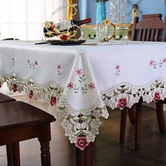 the table cloth is white with red flowers on it