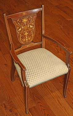 a wooden chair sitting on top of a hard wood floor