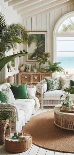 a living room filled with white furniture and lots of greenery on top of it