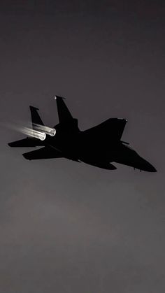 a fighter jet flying in the sky at night