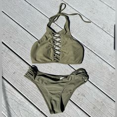 Like New Olive Green Hollister 2 Piece Bikini! Top Is Xs And Bottom Is Small. Hello Summer, Super Flattering Top And Bottom With Peep Thru String Details At Top And Bottom Sides. Cute Ruched Bottom In The Back! Removable Pads In Top. Adjustable Top Back And Draw String Ties At Neck. Very Pretty Olive Or Army Green. Never Worn It Was Too Small For Me. Swimwear Swim Two Piece Summer Bathingsuit Bathing Suit Bikini Fitted Summer Swimwear With Crisscross Straps, Crisscross Straps Tankini For Sunbathing In Beach Season, Summer Pool Tankini With Crisscross Straps, Fitted Tankini With Crisscross Straps For Sunbathing, Crisscross Strap Halter Top For Beach Season Pool, Crisscross Straps Halter Top For Beach Season, Halter Top With Crisscross Straps For Beach Season, Beach Season Halter Top With Crisscross Straps, Strappy Fitted Swimwear For Beach Party