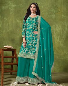 This Sea Green Dola Silk Jacquard Zari and Sequins Embroidered Palazzo Salwar Kameez is a luxurious choice for any occasion. The intricate embroidery on the neckline and sleeves of the kameez adds a touch of elegance, while the work on the ghera provides a unique and sophisticated look. The dupatta in chinnon silk fabric features zari booties all over with dense work on borderline, completing the stunning ensemble. Plus, the matching palazzo style bottom in santoon fabric comes with embroidery on bottom. Plazzo Dress, Designer Salwar Kameez, Palazzo Suit, Indian Wedding Wear, Silk Bottoms, Party Kleidung, Salwar Kameez Designs, Anarkali Suit, Pakistani Suits