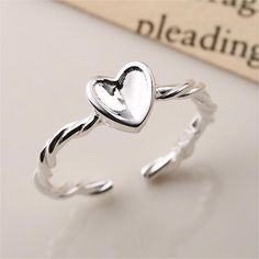 Add a touch of glamour to your look with this Twisted Knitting Heart Adjustable Plain Ring. Crafted from high-quality material, this ring features an adjustable fit for all sizes. The elegant heart design is sure to turn heads and add a touch of style to any outfit. Product Details Material: 925 Silver Color: White Gold Plated Size: US Size #8 Adjustable Weight: about 2.4g SKU: AR23101931 Product Keywords: Distorted band rings, Avante-garde rings, Unique shaped rings, vintage rings, vintage band Trendy Silver Heart Ring For Valentine's Day, Trendy Adjustable Heart-shaped Rings, Trendy Silver Heart-shaped Ring, Trendy Silver Heart Rings, Trendy Silver Heart Promise Ring, Silver Trendy Heart Promise Ring, Adjustable Heart-shaped Elegant Midi Rings, Trendy Heart-shaped Open Promise Ring, Trendy Open Heart Promise Ring