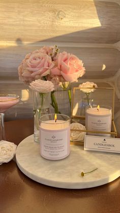 candles and flowers are sitting on a table