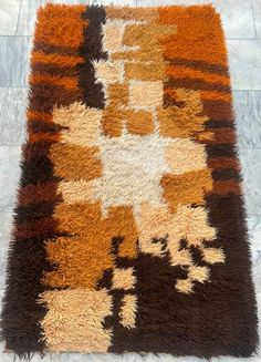 an orange and brown rug on the floor