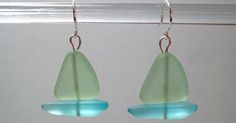 the earrings are made from sea glass and have blue tears on each earring