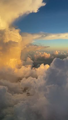 the view from an airplane looking down on clouds