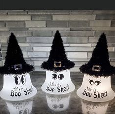 three halloween decorations are sitting on a counter top in front of a brick wall, with the words boo sheet written on them