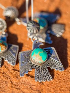 A great addition to the Thunderbird lineup, our Thunderbird earrings! Traditional antiquity styled Thunderbird in 16 gauge sterling silver. Native made, with Kingman turquoise center. These pendants have some significant meaning. According to Native legends, Thunderbirds are described as a supernatural being, and a symbol of power and strength that protected humans from evil spirits. The Thunderbird of the Sioux People was a noble creature that protects humans from the Unktehila, who were danger Southwest Jewelry Eagle Rock Trading Post, Western Jewelry Earings, Silver Bohemian Jewelry With Bird Design, Bohemian Silver Jewelry With Bird Design, Silver Patina Drop Earrings, Silver Drop Earrings With Patina, Sterling Silver Patina Earrings, Thunderbird Jewelry, Jewlery Rings