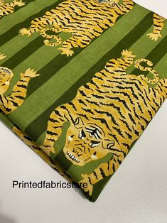 a green and yellow tiger print fabric