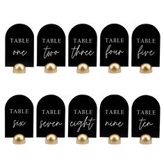 black and gold place card holders with white lettering on each side, set of 12