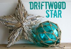 driftwood star and blue glass ornament sitting on top of a wooden table