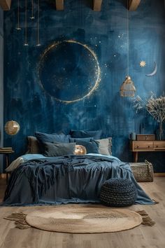 a bedroom decorated in blue and gold with a large moon on the wall above the bed