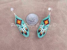 two beaded earrings sitting next to a penny