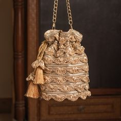 Contemporary Gota Lace Embellished Luxurious Bridal Party Pouch with Sling Chain | Stylish Round-Shaped Fashion Accessory Drawstring Purse Package Contents: 1 Size: 10" x 8" Designed with the heart, this beautiful Potli or batawa bag are eye catchy and made of premium material. Key Features: This potli is good match with both Indian and western outfits and are superb for wedding and festive parties. This would be best complement to your designer saree, lenhga or any other kind of dress. This is the combination of traditional and modern embroidery work. This is enough to keep your accessories and all needed essentials and it can be a best gift for any woman. Festive Evening Bags With Tassels, Festive Gold Bag With Tassels, Festive Celebration Bags With Tassels, Festival Potli Bag With Tassels For Party, Elegant Festive Bags With Tassels, Elegant Festive Tassel Bags, Festive Party Bags With Tassels, Gold Potli Bag With Tassels For Festivals, Festive Elegant Potli Bag With Tassels