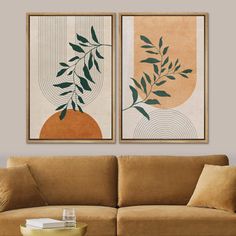 two paintings hanging above a couch in a living room