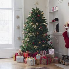 a living room with a christmas tree and presents