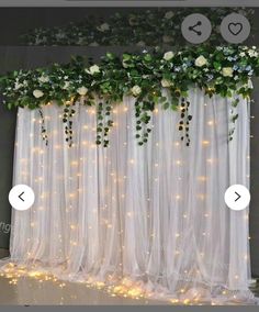 a white curtain with flowers on it and some lights in the room next to it