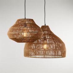 two lamps made out of wicker hanging from the ceiling