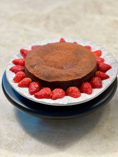 a chocolate cake with strawberries on a plate