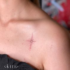 a woman's shoulder with a small star tattoo on her left arm and chest