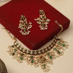 Gift yourself a royal look with this perfectly crafted kundan necklace set from Tarinika. Crafted with high quality kundan stones and pearls, it is impressive in design. The green enamel artwork adds perfect texture to the design. Perfect for weddings and festivities, this antique necklace set should be put on with your favorite sari or lehenga. Specifications: Necklace Weight:74gm, Earring Weight:24gm, Necklace Length:18cm, Earrings Length:8.5cm 100% Satisfaction Guarantee: 1 Year Warranty, Lon Antique Necklace Set, Vintage Indian Jewelry, Kundan Jewellery Bridal, Elegant Choker, Inexpensive Jewelry, Kundan Jewellery Set, Antique Necklaces Design, Kundan Necklace Set, Dodge City