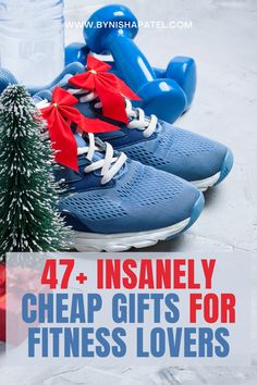 a pair of blue running shoes next to a christmas tree with red and white ribbons