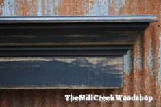 an old window frame is painted blue and rusted