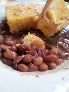 a white plate topped with beans and bread