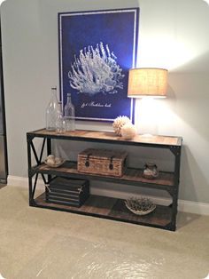 a living room with a shelf and lamp on the side table in front of it