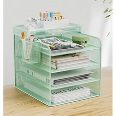 a desk organizer with magazines and pens on it