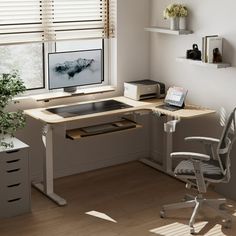 a computer desk with a monitor and keyboard on top of it in front of a window