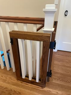 a wooden stair banister with white railing