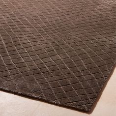 a brown rug on the floor with an interesting design