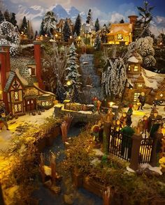 a christmas village is shown with lights and trees