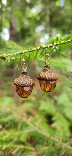 Bring the beauty of the outdoors into your Fall look with these captivating acorn earrings. The intricate, nature-inspired design adds an enchanting, earthy elegance that's perfect for the crisp, colorful days of Fall. Wear them to the office, out with friends, or to your next seasonal celebration - these earrings will elevate any ensemble with their timeless charm. Acorn earrings measure approximately 40mm from top of bead and loop wire to bottom of earring bead, and approximately 17mm wide at Cool Bead Designs, Acorn Cap Earrings, Crafty Gift Ideas For Friends, Fall Bead Jewelry, Nature-inspired Dangle Earrings, Nature-inspired Dangle Jewelry In Natural Color, Nature-inspired Natural Color Dangle Jewelry, Brown Dangle Earrings Nature-inspired, Nature-inspired Brown Earrings With Ear Wire