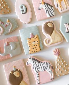 decorated cookies are arranged in the shape of animals