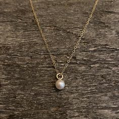 Dainty and minimal - gold filled necklace with a Swarovski pearl centre. Beautiful and elegant . Chain is adjustable Material : 14K gold filled Size : 5mm pearl Length : 16+2 inches Comes in a gift boxGold filled should NOT be confused with gold plating. It is an actual layer of solid gold, pressure bonded to another metal. Gold filled not only uses the double amount of gold , It’s also more valuable and tarnish resistant and does not flake or rub off. It's great for people that have skin sensit Dainty Pearl Charm Necklace In 14k Gold, Minimalist 14k Gold-filled Pearl Necklace For Everyday, Minimalist Everyday Pearl Necklace With 14k Gold Filled, Dainty 14k Gold Filled Pearl Necklace For Everyday, Everyday Minimalist Pearl Necklace In 14k Gold, Minimalist Gold Charm Necklace With Pearl, Dainty 14k Gold Necklace With Pearl Charm, Everyday Minimalist 14k Gold-filled Pearl Necklace, Minimalist Everyday 14k Gold Filled Pearl Necklace