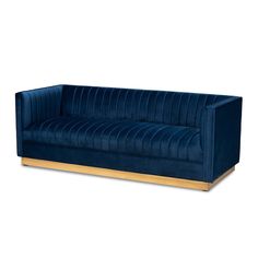 a blue velvet couch with gold legs